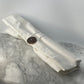 Nirvana Cutlery Collection white cotton roll pouch tied closed with a coconut shell button on a marble surface, eco-friendly travel cutlery storage by Koko Loko
